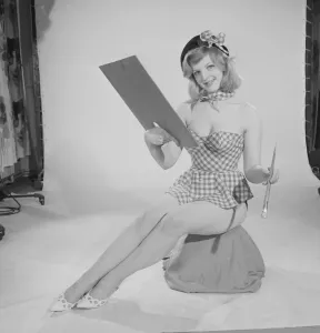 Beret Prints: Reveille art Feature. Model Peggy Cage seen here wearing a check short summer dress