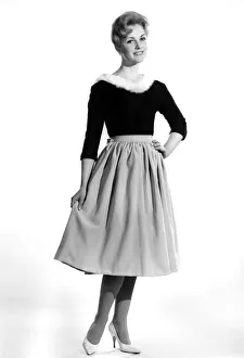 Reveille Fashions 1961: Roma Reeves modelling a fur trimmed sweater and skirt