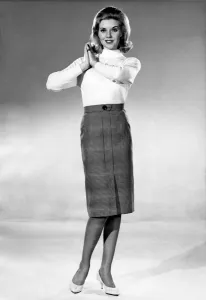 Reveille Fashions 1964: Maureen Walker modeling a jumper and a knee length pencil skirt
