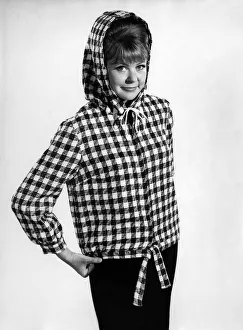 Reveille Fashions 1966: Ann Jarvis wearing check hoodie coat. January 1966 P006671