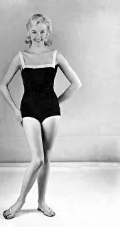 00053 Prints: Reveille Fashions. Model wearing a one piece swimming costume and flip flop shoes