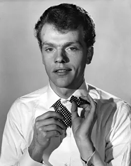 Reveille Fashions: Peter Hamilton-Davies attempts to tie a pollka dot bow tie