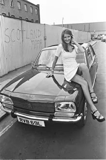 Reveille model Beulah Hughes seen here posing with a Peugeot 504 car which is a top prize