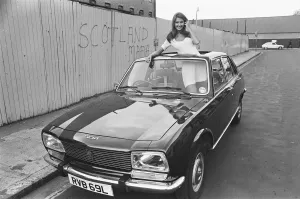 Reveille model Beulah Hughes seen here posing with a Peugeot 504 car which is a top prize