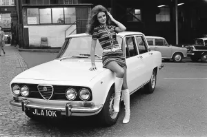 Reveille model seen here posing with a Alfa Romero car which is top prize in the Reveille