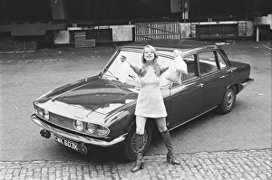 Reveille model seen here posing with a Triumph 2000 which is top prize in the Reveille
