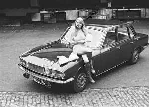 Reveille model seen here posing with a Triumph 2000 which is top prize in the Reveille