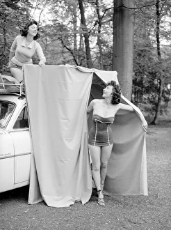 Invention Prints: Two reveille models seen here demonstrating the new car rack tent