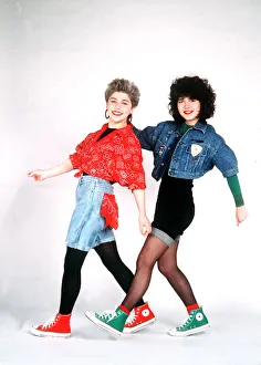 The Reynolds Girls wearing shirts shorts trainers and tights, dancing