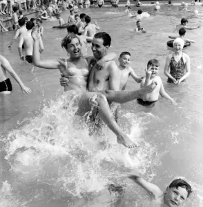 Rhyl bathing pool. Pauline Jones, 23, of Rhyl in the arms of her brother-in-law John