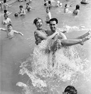 Rhyl bathing pool. Pauline Jones, 23, of Rhyl in the arms of her brother-in-law John