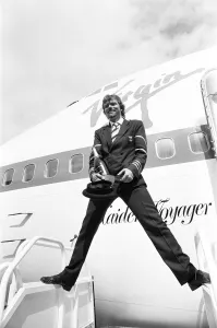 Richard Branson seen here dressed as a Virgin Atlantic pilots with a bottle of champagne