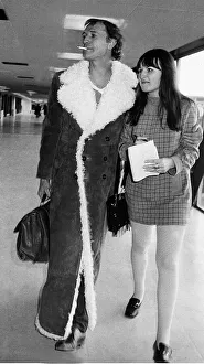 Frowning Prints: Richard Harris Irish actor at Heathrow airport 1970 with arm around female