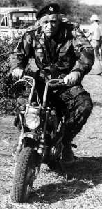 00141 Prints: Richard Harris Irish actor on set of film Wild Geese 1977 riding motorcycle in army