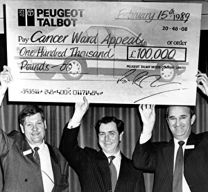 Fund Raising Prints: Richard Parham(right), assistant MD at Peugeot get help with the oversized cheque