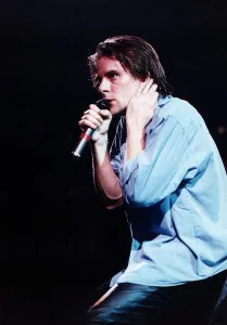 Ricky Ross singer rock band pop group Deacon Blue on stage holding microphone May
