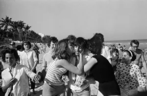 Ringo Starr is besieged by schoolgirls as he strolls on a beach in Miami, Florida