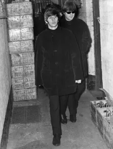 Ringo Starr and John Lennon of the Beatles walking from Stephenson Place through