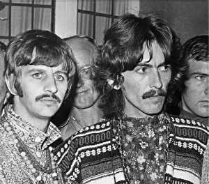 Ringo Starr (left) and George Harrison (right) of The Beatles face the press on the news