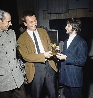 Beatles Colour Prints: Ringo Starr sings into a toy gramaphone after sound engineer Geoff Emerick won a Grammy