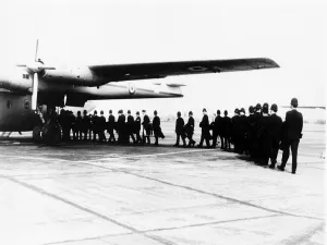Riot squad police entering transport plane on their way to Hastings because of Teenage