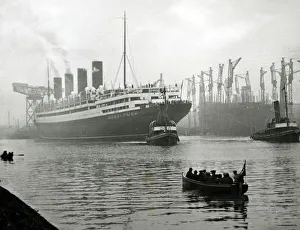 Tugs Prints: RMS Aquitania seen here being towed away from the John Brown shipyard on the River Clyde