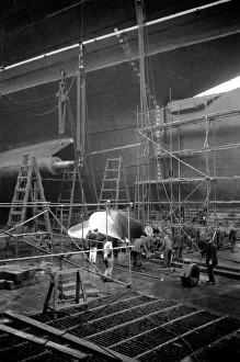 The RMS Queen Mary is in dry dock at Southampton undergoing refitting