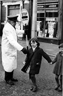 Road Safety - Lollipop Man / Woman - A Lollipop man safely crossing children on a busy