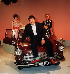 Robbie Coltrane actor pictured sitting on the bonnet of a mini Circa 1990