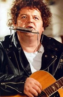 Images Dated 15th August 1989: Robbie Coltrane actor playing harmonica and guitar