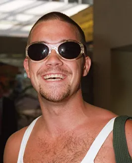 Grinning Prints: Robbie Williams arrives Glasgow Airport T In The Park festival August 1995