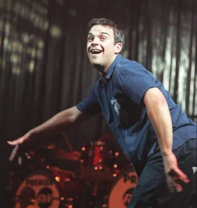 Robbie Williams dances at his concert at the SECC Glasgow February 1999