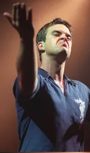 Grimace Prints: Robbie Williams makes a face to the audience at his concert at the SECC Glasgow February
