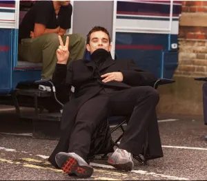 Robbie Williams relaxes on the set of his lastest video being shot in the grounds of