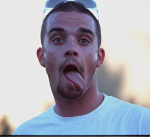 Robbie Williams sticking his tongue out to photographers at T in The Park festival
