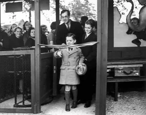 Robert Kennedy (right) watches his younger brother Edward Kennedy cut the tape to open