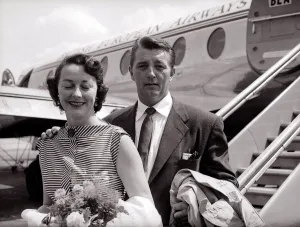00091 Prints: Robert Mitchum and his wife - July 1955 arrive at the London Airport