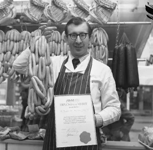 Tyne And Wear Prints: Robert Thompson Dix in his North Tyneside shop holds a string of sausages