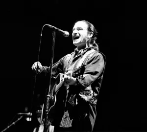 Rock group U2 in concert in USA - May 1987 Bono singing and playing guitar