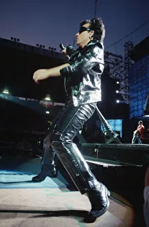 00684 Prints: Rock group U2 performing on stage at Cardiff Arms Park led by singer Bono