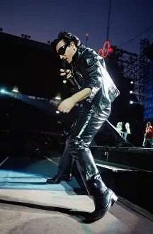 Rock group U2 performing on stage at Cardiff Arms Park led by singer Bono