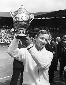 Rod Laver tennis player hold mens singles Wimbledon trophy aloft