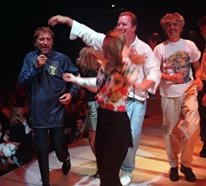 Rod Stewart pop star wearing a Scotland football strip singing on stage during his