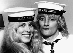 Rod Stewart singer with Alana Hamilton wearing Royal Navy HMS Ark Royal Caps during a