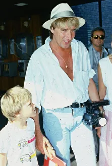 00054 Prints: Rod Stewart singer June 1986 with his son Sean at Glasgow Airport