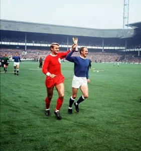 Roger Hunt football player for Liverpool and Ray Wilson of Everton run around Goodison