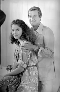 France Prints: Roger Moore with actress Lois Chiles at a photocall and reception held in Paris to