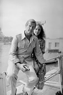 Roger Moore with actress Lois Chiles at a photocall and reception held in Paris to