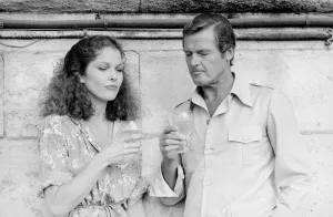 Roger Moore with actress Lois Chiles at a photocall and reception held in Paris to