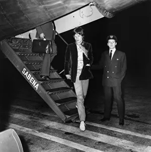 00174 Prints: Rolling Stones: Mick Jagger disembarks at Heathrow Airport from his flight home
